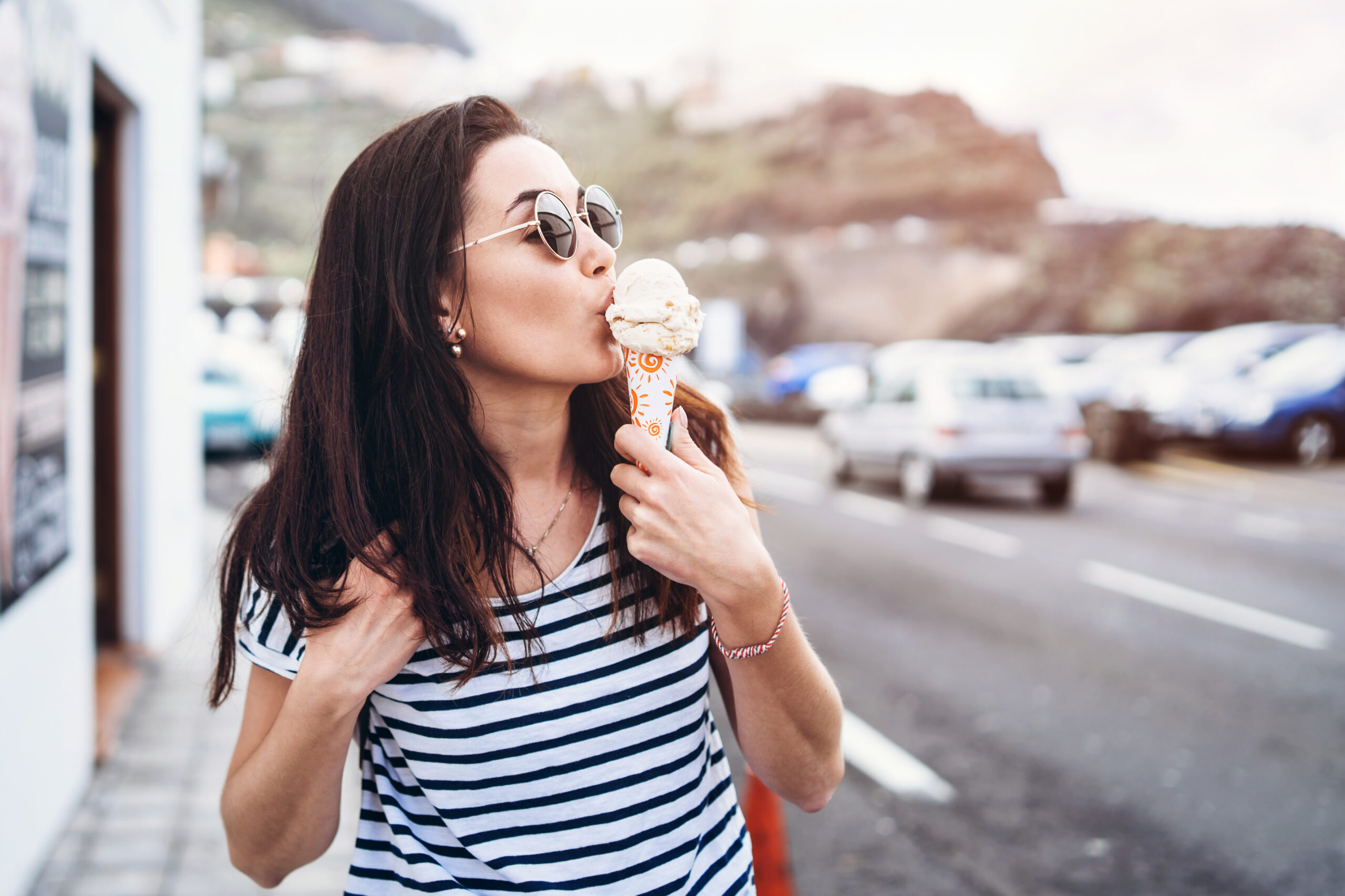 Pretty,Brunette,Girl,Eating,Ice,Cream,And,Walking,Outdoor,On